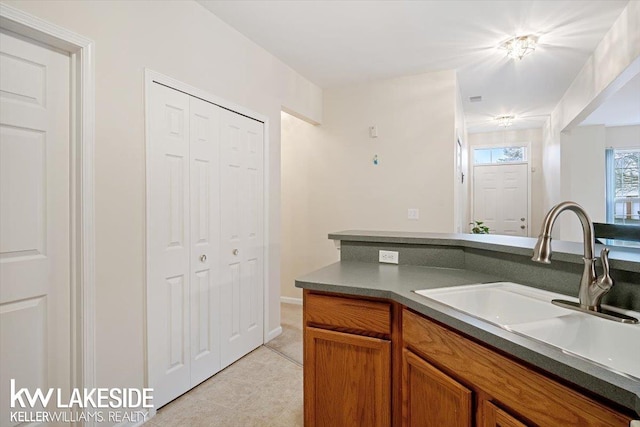 kitchen with light tile patterned flooring and sink