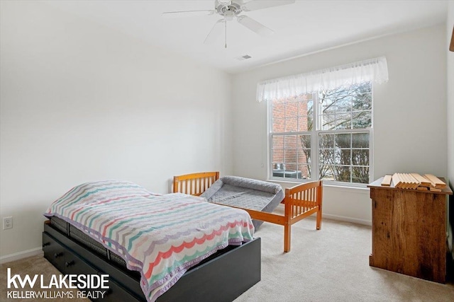 carpeted bedroom with ceiling fan and multiple windows