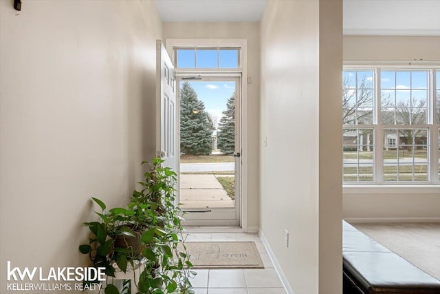 doorway with light tile patterned flooring