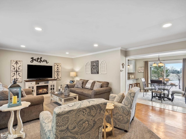 living room featuring ornamental molding and light hardwood / wood-style flooring