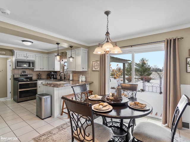 tiled dining area with ornamental molding and sink