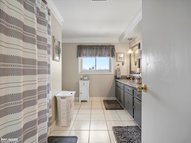 bathroom with tile patterned flooring, ornamental molding, and vanity