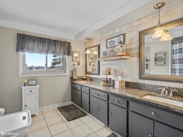 bathroom with tile patterned flooring, ornamental molding, and vanity