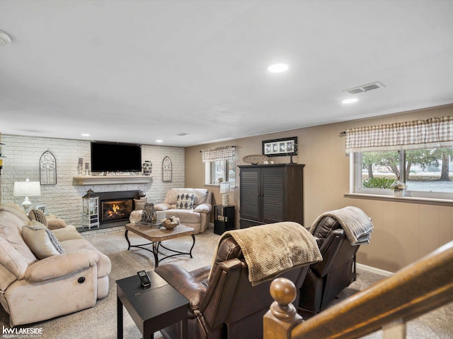 living room featuring a large fireplace and light colored carpet