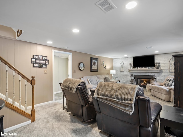 living room with carpet and a fireplace