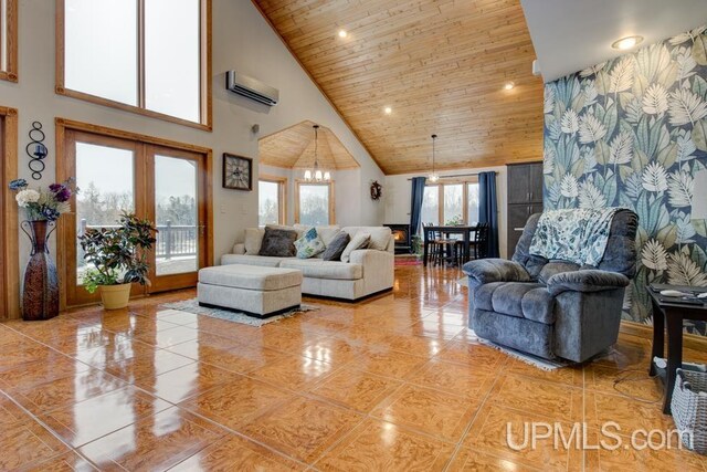 living room with wood ceiling, tile patterned flooring, a notable chandelier, a wall mounted air conditioner, and high vaulted ceiling