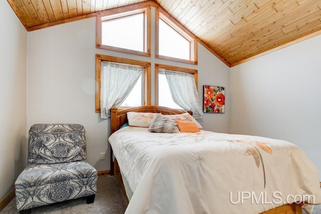 bedroom featuring lofted ceiling, wooden ceiling, and carpet