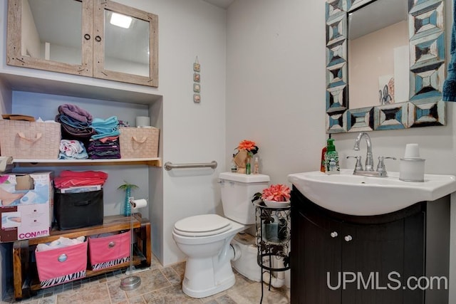 bathroom featuring toilet and vanity