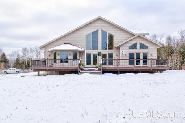 snow covered property featuring a deck