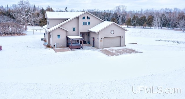 view of front of property featuring a hot tub and a garage