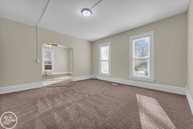 empty room with ceiling fan and carpet