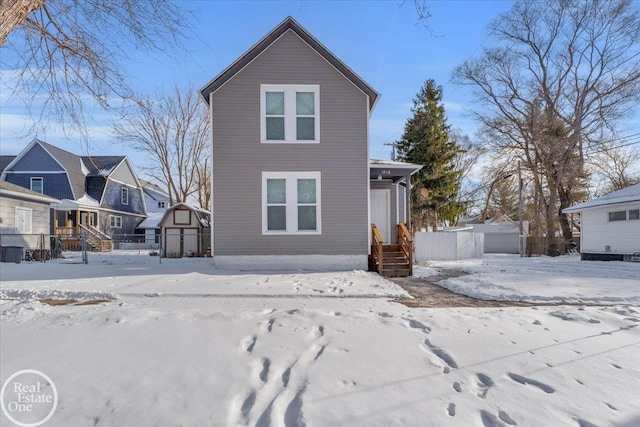 view of snow covered rear of property