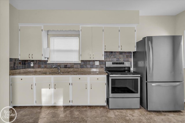 kitchen featuring appliances with stainless steel finishes, backsplash, white cabinetry, and sink