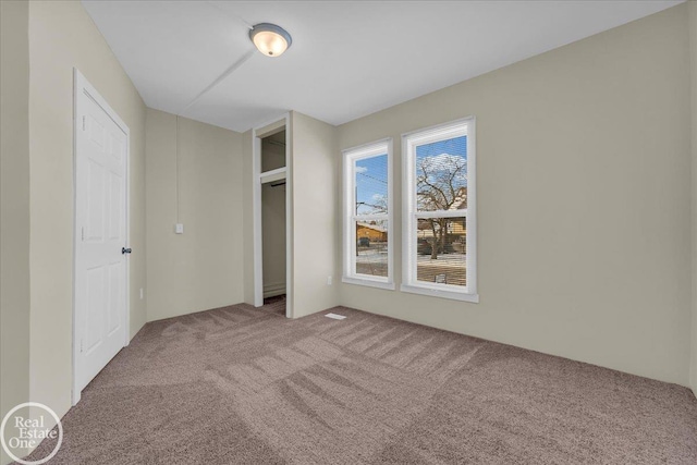 unfurnished bedroom with a closet and carpet flooring