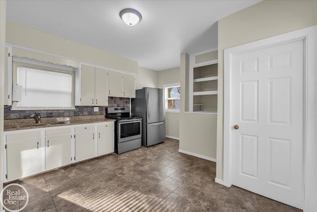 kitchen with appliances with stainless steel finishes, white cabinetry, decorative backsplash, sink, and stone countertops