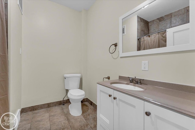 bathroom with toilet, tile patterned flooring, a shower with curtain, and vanity