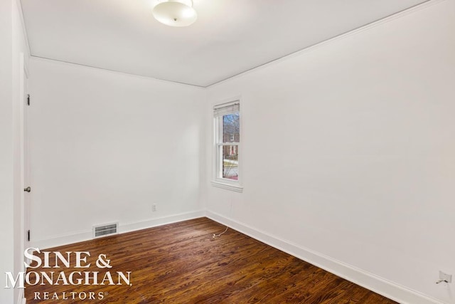 unfurnished room with hardwood / wood-style flooring