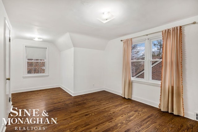 additional living space with lofted ceiling and dark hardwood / wood-style flooring