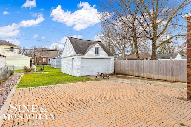 exterior space with a garage and an outbuilding