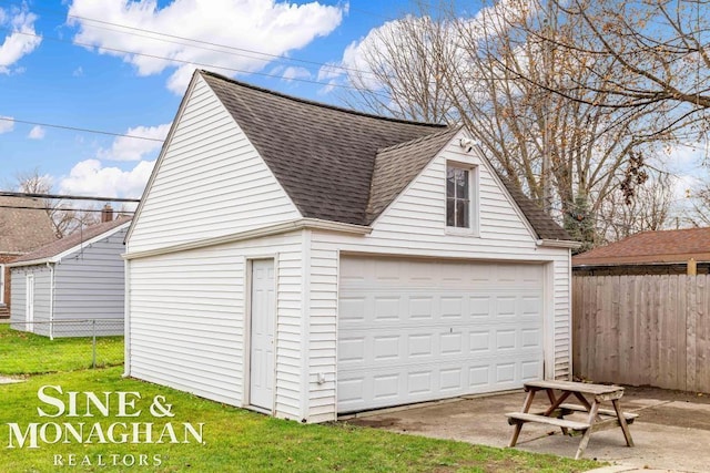 garage featuring a lawn