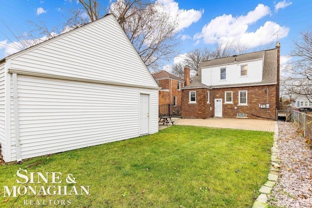 rear view of property featuring a yard and a patio