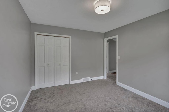 unfurnished bedroom featuring a closet and carpet