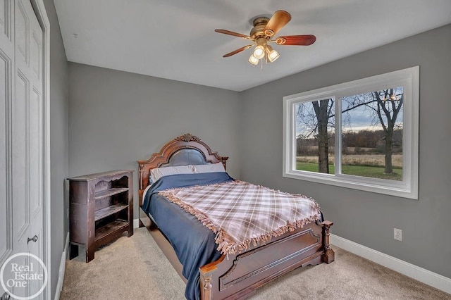 carpeted bedroom with ceiling fan