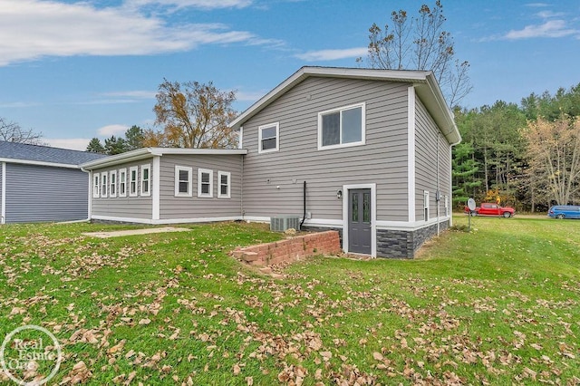 back of house featuring cooling unit and a yard