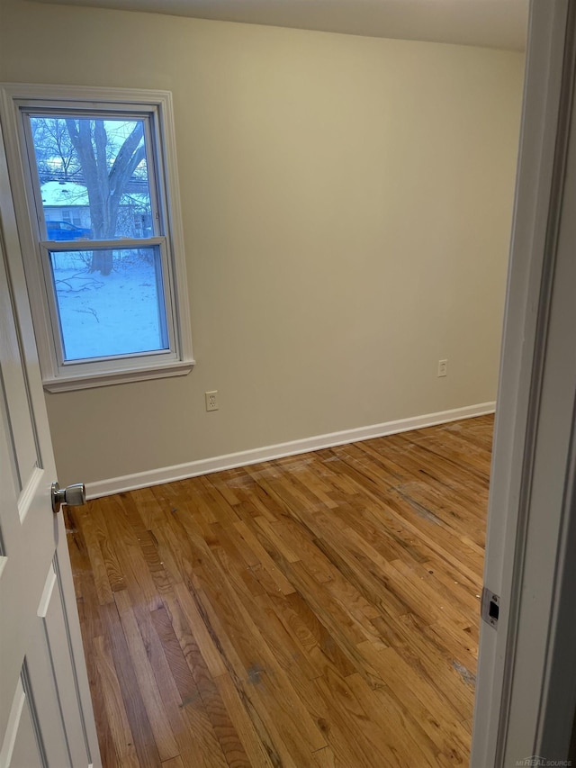 empty room with light hardwood / wood-style flooring