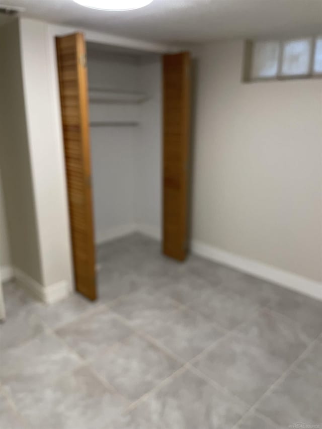 unfurnished bedroom featuring a closet and light tile patterned flooring