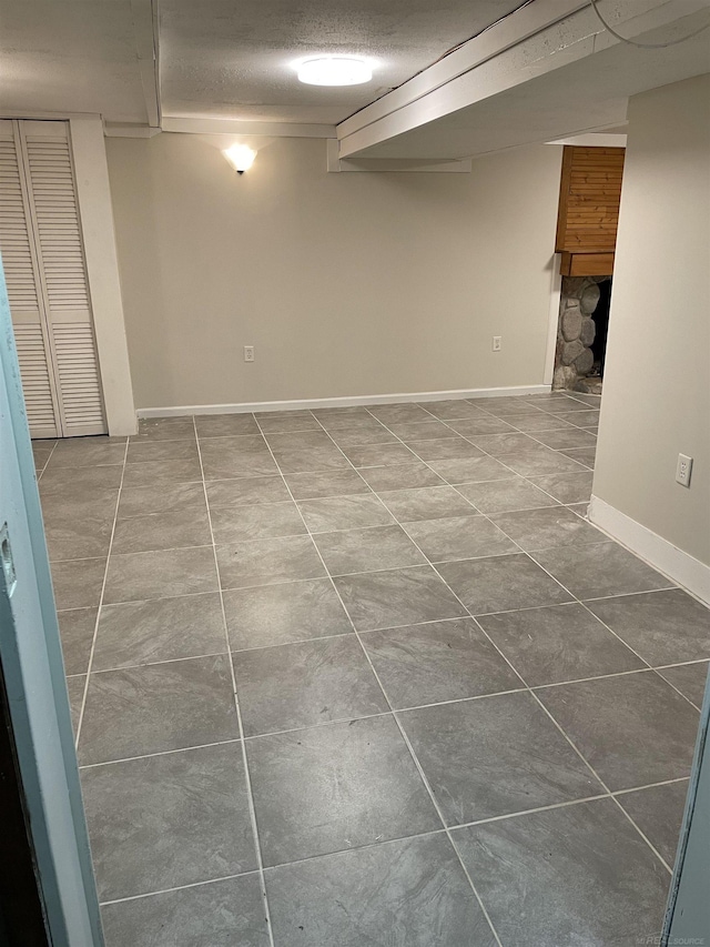 basement featuring a textured ceiling