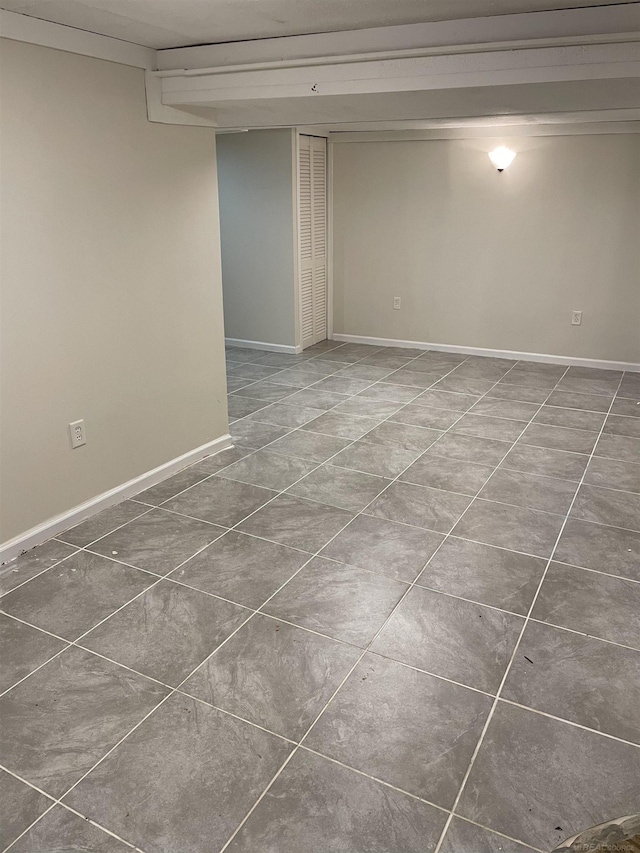 empty room with dark tile patterned flooring