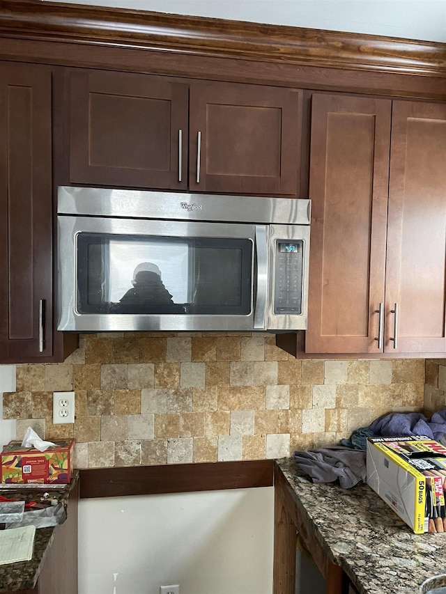 kitchen with dark stone counters and decorative backsplash