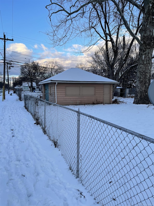 yard layered in snow featuring a garage