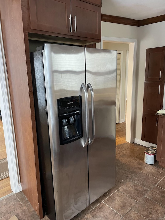 kitchen with ornamental molding, stainless steel fridge, and dark brown cabinets