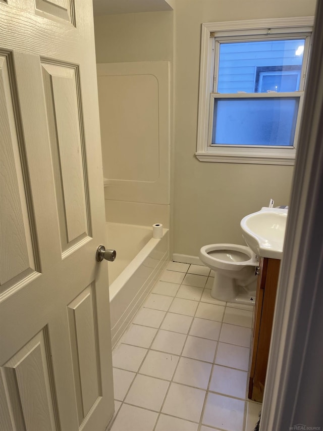 bathroom with toilet, tile patterned floors, and vanity