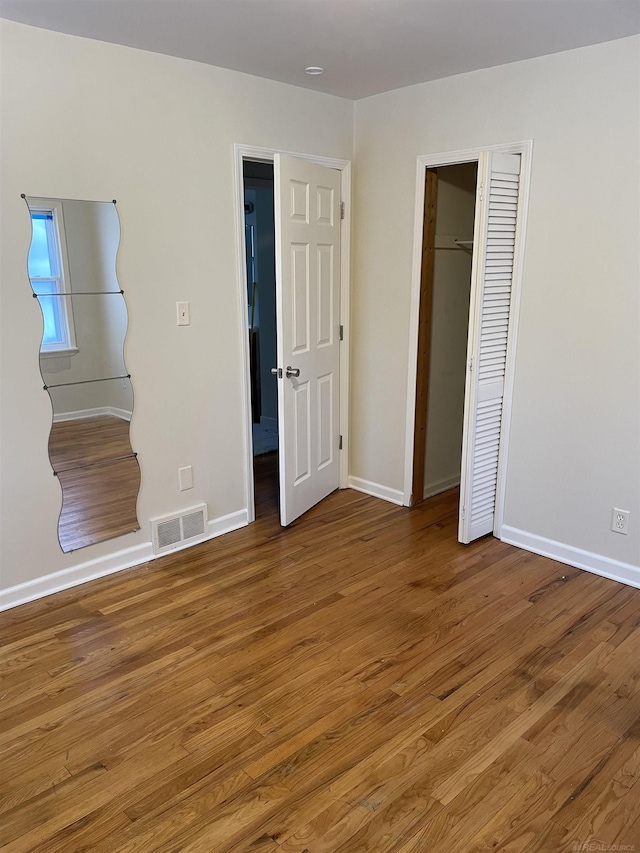 unfurnished bedroom with hardwood / wood-style floors