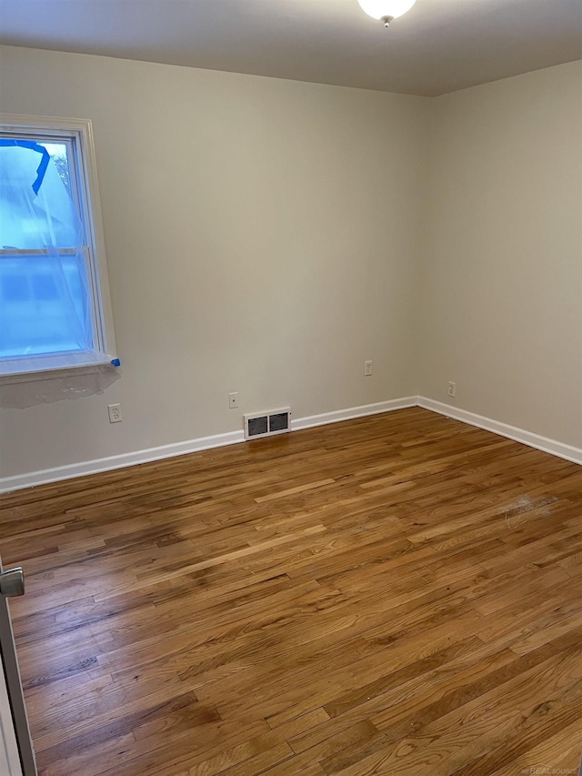 spare room with hardwood / wood-style flooring