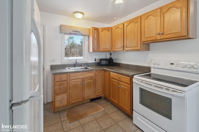 kitchen featuring white appliances, light tile patterned floors, and sink