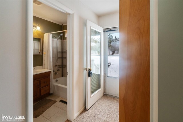 bathroom featuring shower / bathtub combination with curtain, a healthy amount of sunlight, and vanity