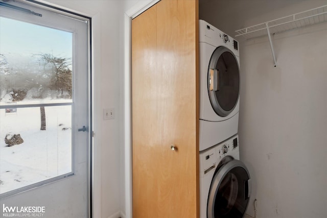 laundry room featuring stacked washer / drying machine