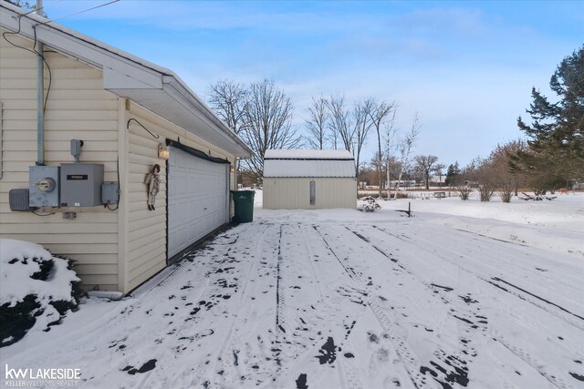 snowy yard with a shed