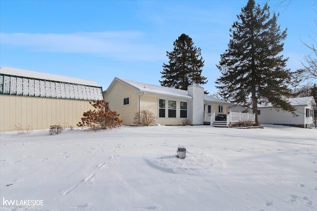 snow covered property with a wooden deck