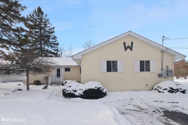 view of snow covered rear of property