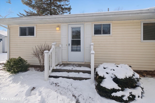 view of snow covered property entrance