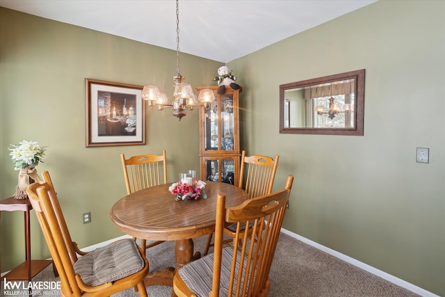 dining area with an inviting chandelier and carpet