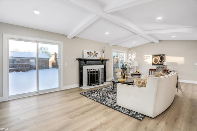 living room with wood-type flooring and vaulted ceiling with beams