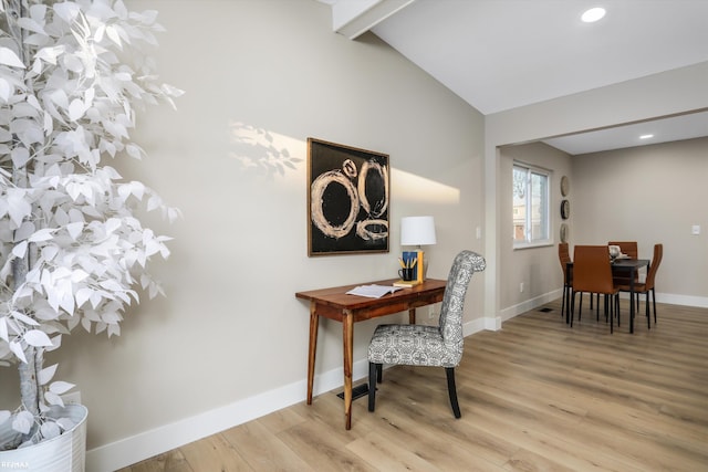 office featuring light hardwood / wood-style flooring and vaulted ceiling with beams