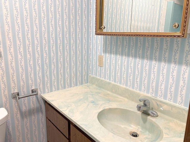 bathroom featuring toilet and vanity