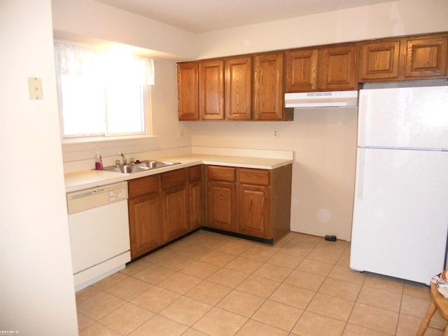 kitchen featuring sink, white appliances, and light tile patterned flooring